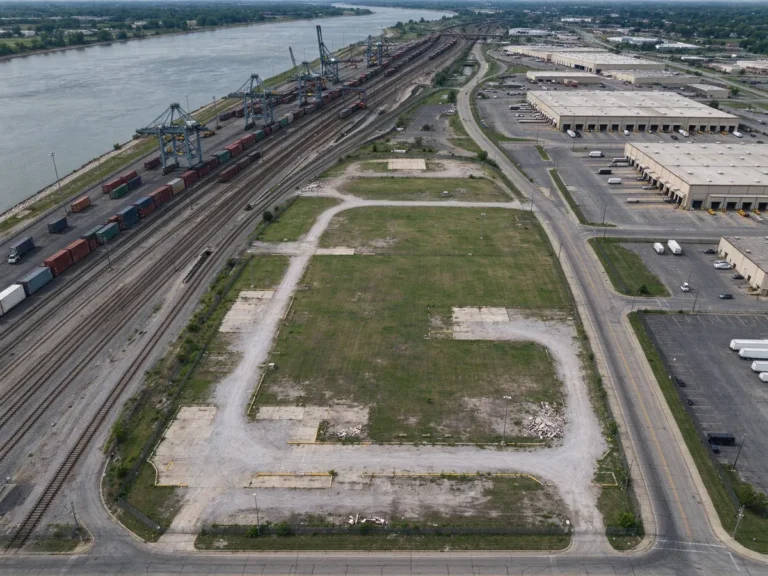 Aerial view of a vacant former casino site beside rail yards and distribution warehouses